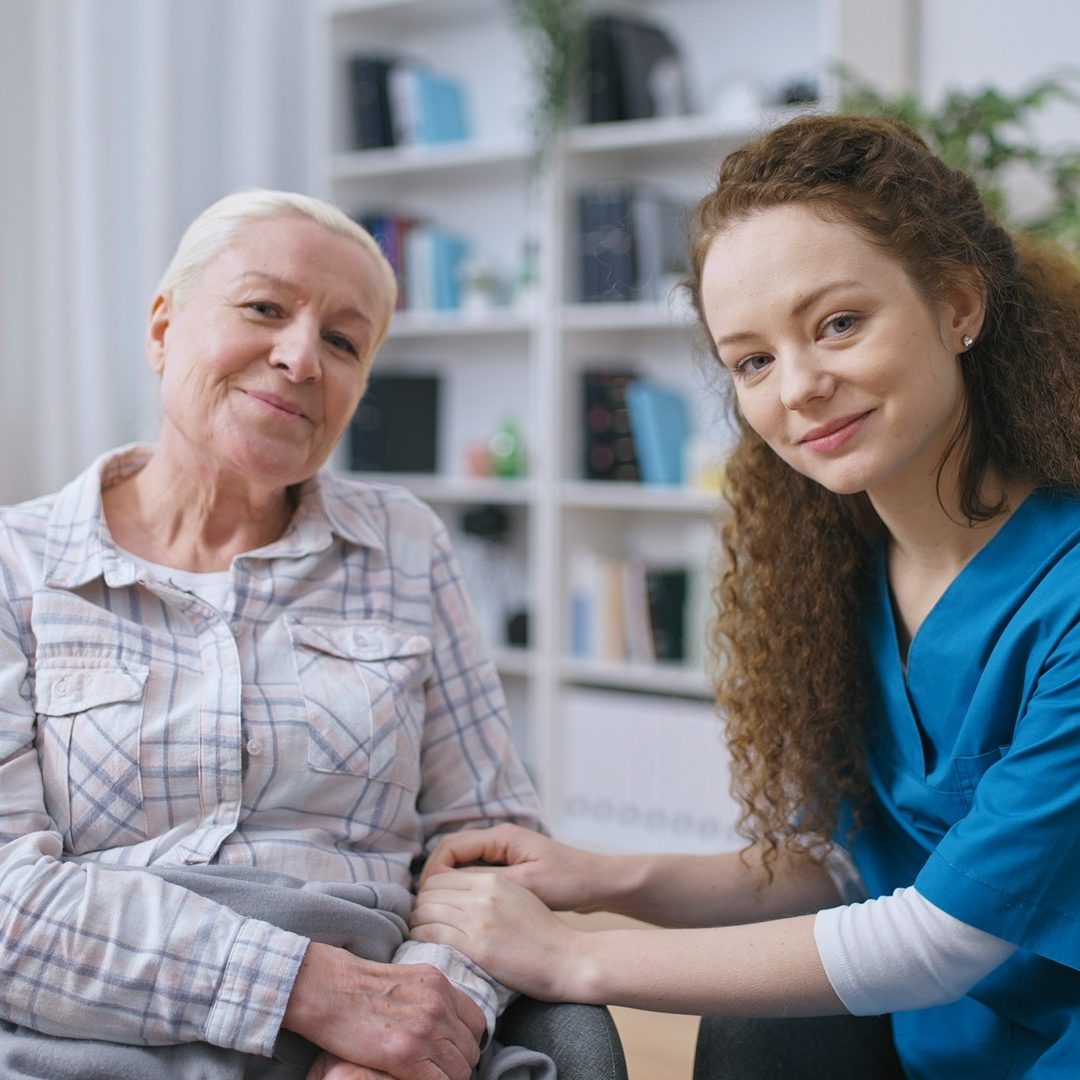 Caregiver Holding Hands Of A Senior Woman